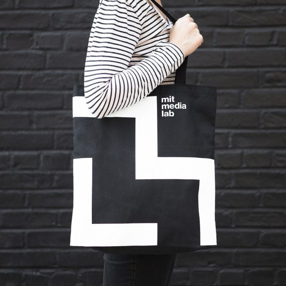 MIT media lab is an example of a flexible brand, displayed on a tote bag.