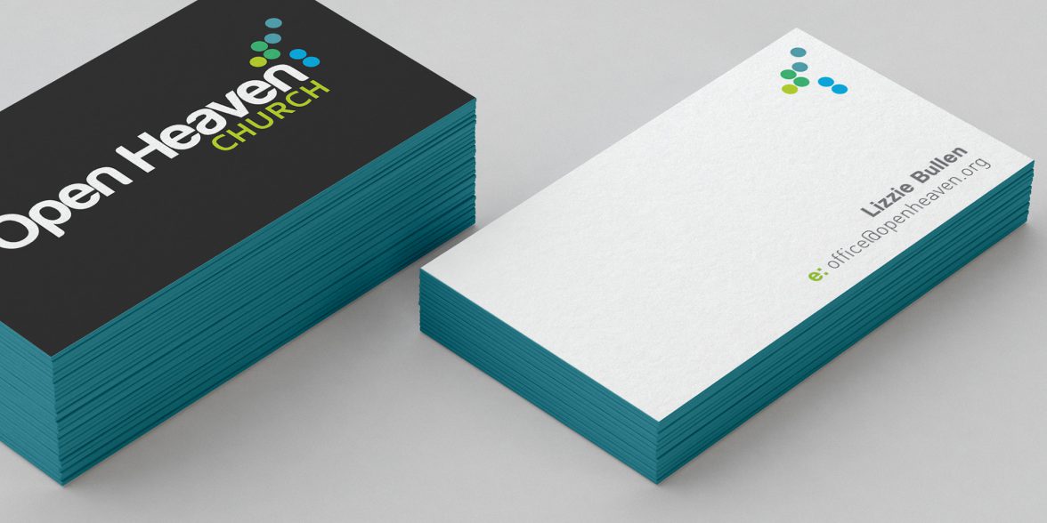 A stack of business cards for Open Heaven church, based in Loughborough.